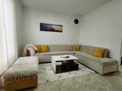 a living room with a couch and a table at Apartman MAJ in Bijelo Polje