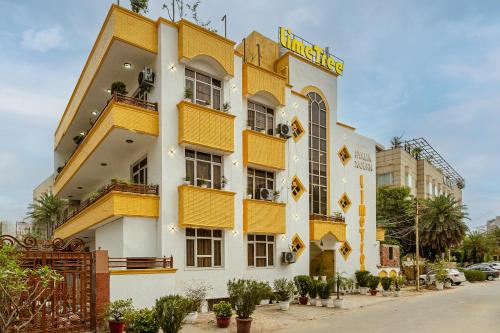 a building with yellow balconies on a street at Lime Tree Hotel Huda City Centre in Gurgaon