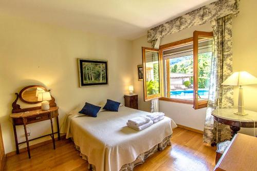 a bedroom with a bed and a window at Picturesque Costa Brava Countryside Villa in Les Planes d'Hostoles