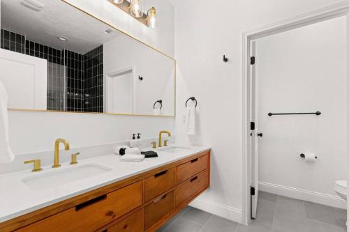 a white bathroom with a sink and a mirror at Pool-MovieTheater KING BED & 5 minutes to Alamodome in San Antonio