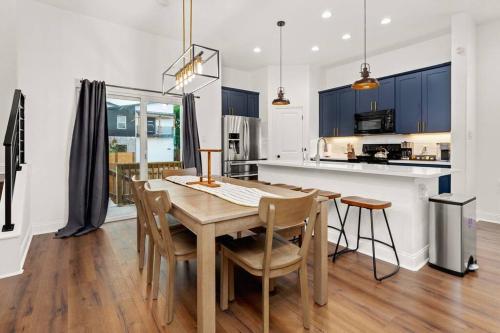 a kitchen and dining room with a wooden table and chairs at Pool-MovieTheater KING BED & 5 minutes to Alamodome in San Antonio