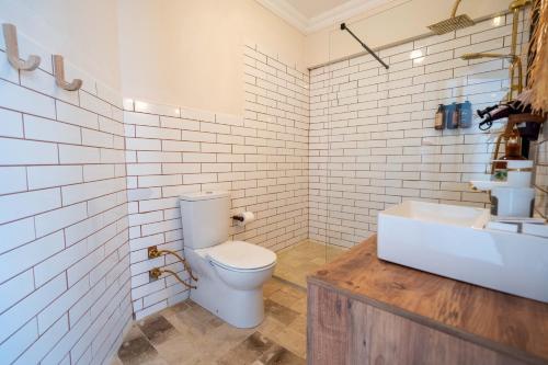 a bathroom with a toilet and a sink at CasaLyma Ayvalık in Ayvalık
