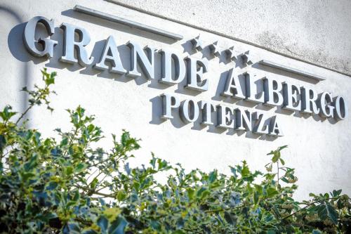 a sign on the side of a building at Grande Albergo Potenza in Potenza