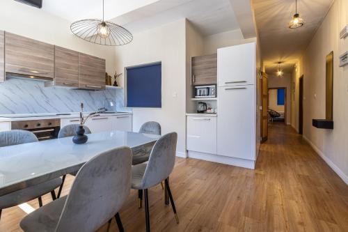 a kitchen and dining room with a table and chairs at Park Lane Boutique Aparthotel in St Paul's Bay