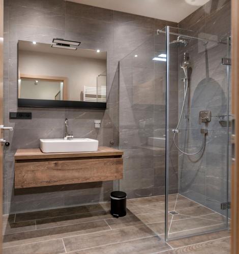 a bathroom with a sink and a shower at Residenz Illyrica Tirol in Westendorf