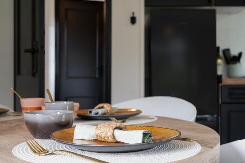 a wooden table with two plates of food on it at Hotel chique chalet met zicht over de weilanden op de Veluwe in Epe