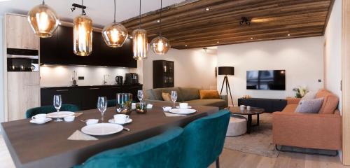 a kitchen and living room with a table and chairs at Residenz Illyrica Tirol in Westendorf