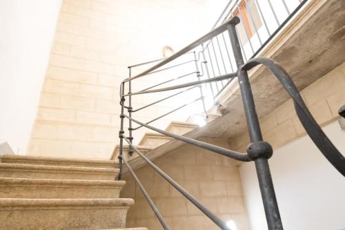 a staircase in a building with a metal railing at Fardella 250 in Trapani