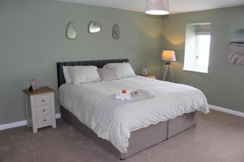 a bedroom with a bed with a cake on it at Seashell Cottage in Llanddulas