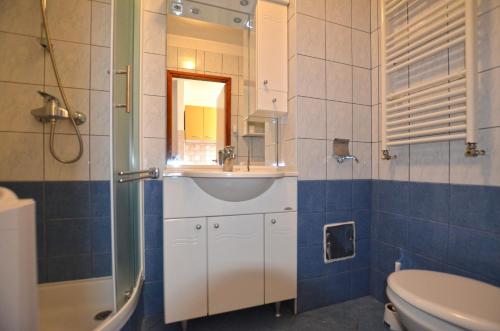 a bathroom with a sink and a shower and a toilet at Apartments Greta in Rovinj