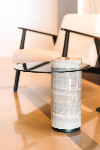 a glass vase sitting on a table with a chair at Miramar in Ulcinj