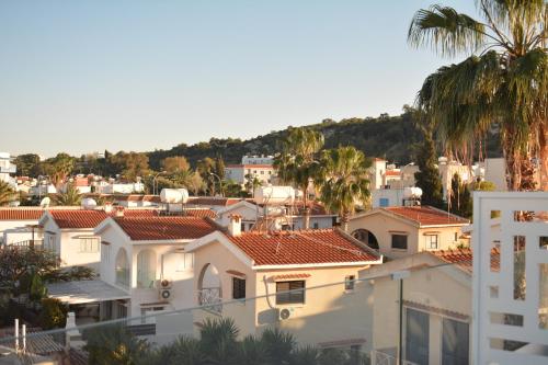 a view of a city with houses and palm trees at Green Bay Suites in Protaras