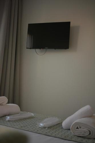 a room with a flat screen tv on a wall at Green Bay Suites in Protaras