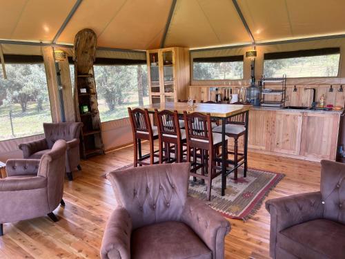 a kitchen with a table and chairs in a tent at Nyumba ya Farasi in Naivasha
