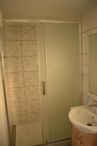 a bathroom with a shower and a sink at Green Bay Suites in Protaras