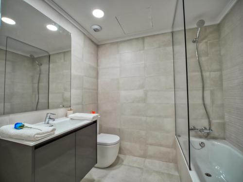 a bathroom with a sink and a shower and a toilet at Amara Prime San Sebastian in Donostia-San Sebastián