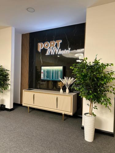 a room with a table with two potted plants at PORT INN Hotel in Astana