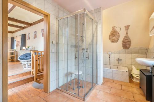 a bathroom with a shower and a sink at Ferienwohnung Baumann in Schwarzenberg/Erzgebirge