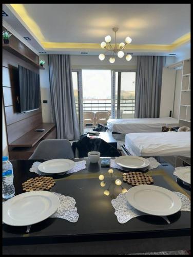 a hotel room with a table with plates on it at Relaxation, fresh air, and a direct view of the Nile in Naj‘ al ‘Amrāb