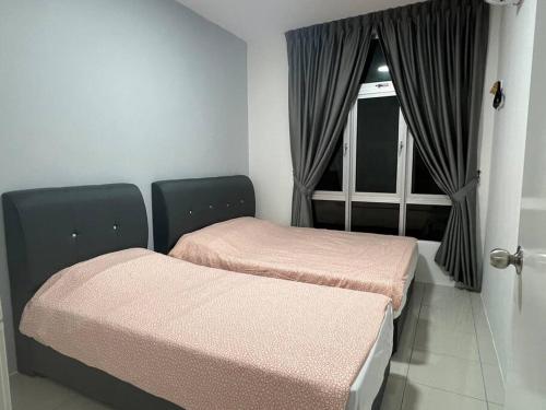 two beds in a room with a window at Ipoh Town Anderson Haru Suite 7 paxs 2R2B in Ipoh