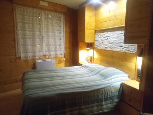 a bedroom with a large bed with a window at Appartement Cauterets in Cauterets