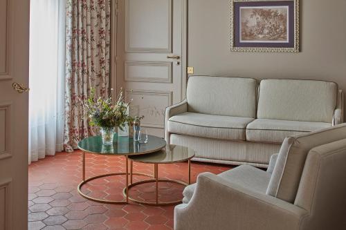 a living room with a couch and a table at Château de Fonscolombe in Le Puy-Sainte-Réparade