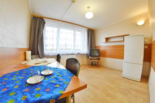 a dining room with a table and a television at Twój Hostel Ruda Śląska in Ruda Śląska