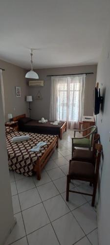 a living room with a bed and a chair at Sette Isole Countryside Retreat Near Egremni Beach Studio 1 in Athani