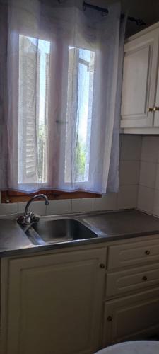 a kitchen with a sink and a window at Sette Isole Countryside Retreat Near Egremni Beach Studio 1 in Athani
