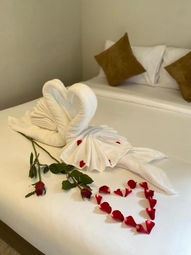 two swans made out of towels on two beds at Flora Hostel KhaoSok in Khao Sok