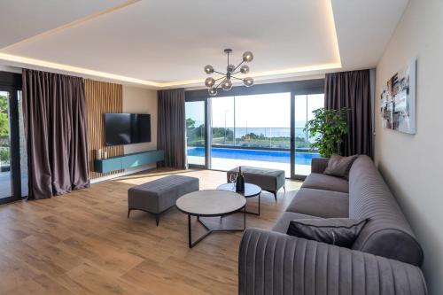 a living room with a couch and a tv at Luxury Villa Sirius, Bast, Makarska Rivijera in Bast