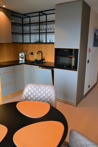 a kitchen with a table and some chairs and a counter at Andenes Suitehotel in Andenes