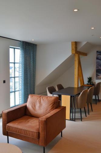 a living room with a couch and a table at Andenes Suitehotel in Andenes