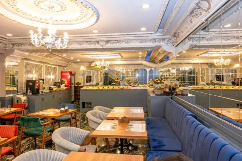 a restaurant with wooden tables and chairs and a bar at Best Nobel HotelS Old City İstanbul-Special category in Istanbul