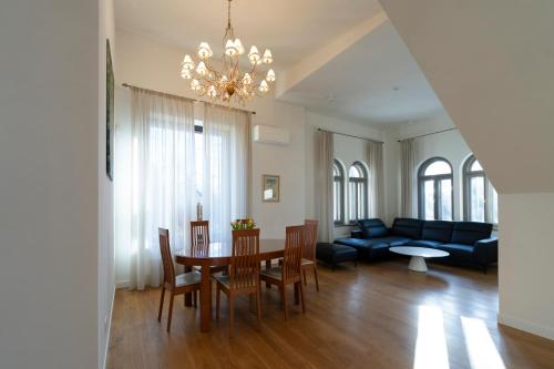 a living room with a table and chairs and a couch at Villa Langberg Spa in Ventspils