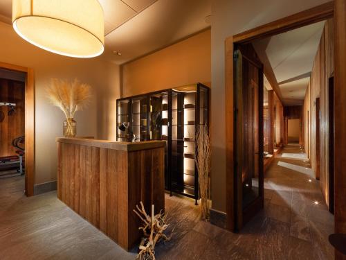 a hallway with a wine cellar with a wooden cabinet and a light fixture at Grand Hotel Della Posta in Sondrio