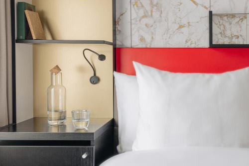 a bedroom with a bed and a bottle on a night stand at Leonardo Boutique Hotel The Lancaster Hotel Amsterdam in Amsterdam