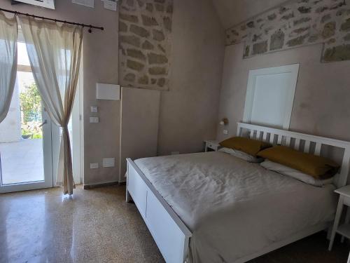 a bedroom with a bed and a large window at Il Panorama di Ercole in Monte di Procida