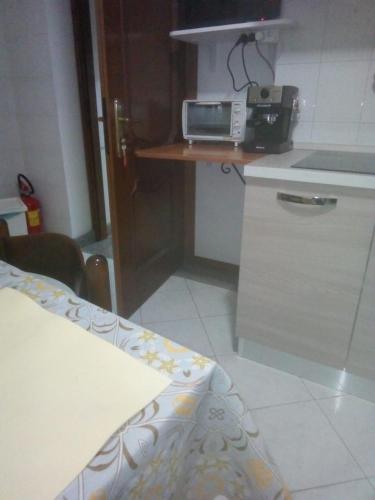 a kitchen with a counter with a toaster oven on a table at Serendipity home in Santa Venerina