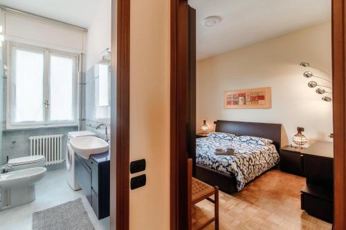 a bedroom with a bed and a sink and a bathroom at Vista Lario Apartment - Aqua Apartments in Cernobbio