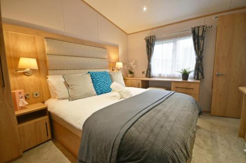 a bedroom with a bed and a window at Tranquility at Chantry Lodge in Clitheroe