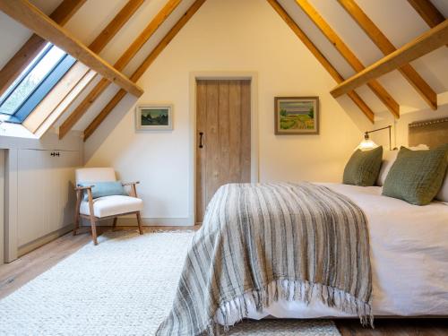 a bedroom with a bed and a window at The Coach House at Stoneythorpe in Southam