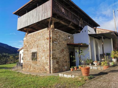 a stone building with a balcony on top of it at MRZ rentals LA CASINA in Cudillero