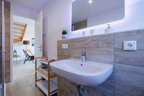 a bathroom with a white sink in a room at Suite Strandrose in Zingst