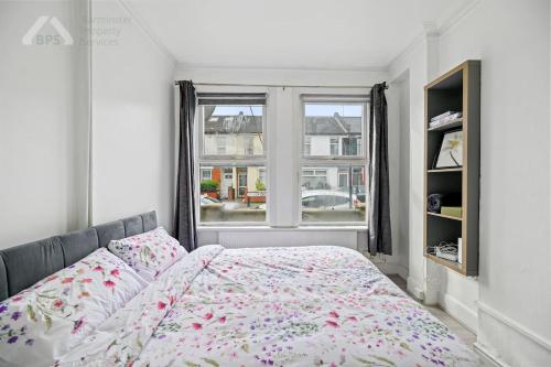 a bedroom with a bed and a window at Cosy Tottenham Apartment sleeps 4 in London