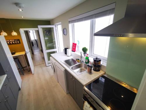 a kitchen with a sink and a counter top at 4BR Modern Botanic House in Belfast