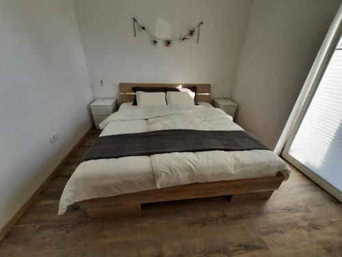 a bedroom with a large bed in a room at Apartment AlpiPond in Kamnik
