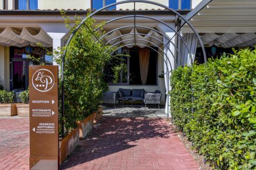 a sign on a brick walkway in front of a building at Albergo Locanda Primavera in Rodengo Saiano