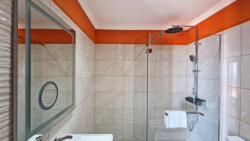 a bathroom with a shower with a glass door at Cliff Refuge by LovelyStay in Santa Cruz