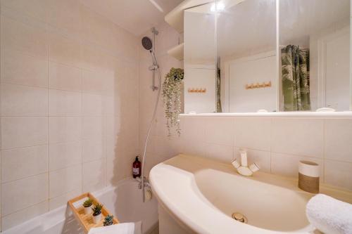 une salle de bain blanche avec une baignoire et un lavabo dans l'établissement L'Hironda - Appt pour 2 - Quartier Saint-Pierre, à Bordeaux